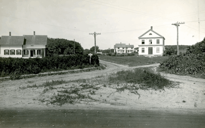 old black and white photo of historic houses and power lines